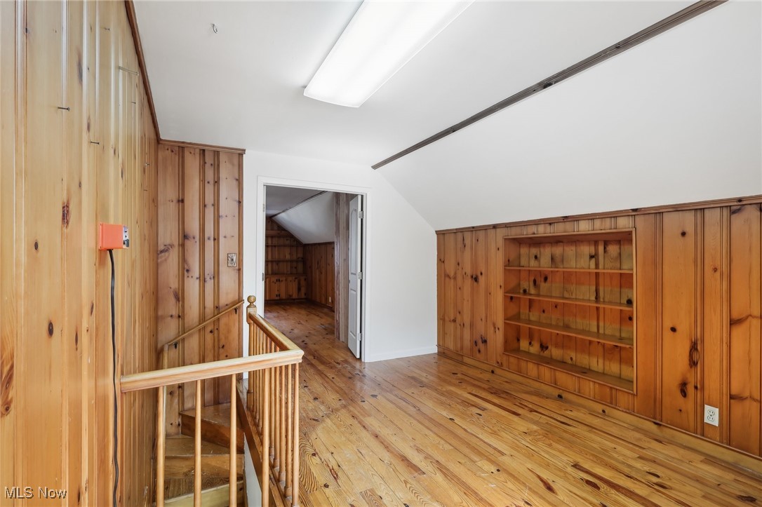 1042 Renfield Road Cleveland Heights, OH 44121 - Photo 25 of 49 Additional living space with light hardwood / wood-style flooring, vaulted ceiling, and wood walls