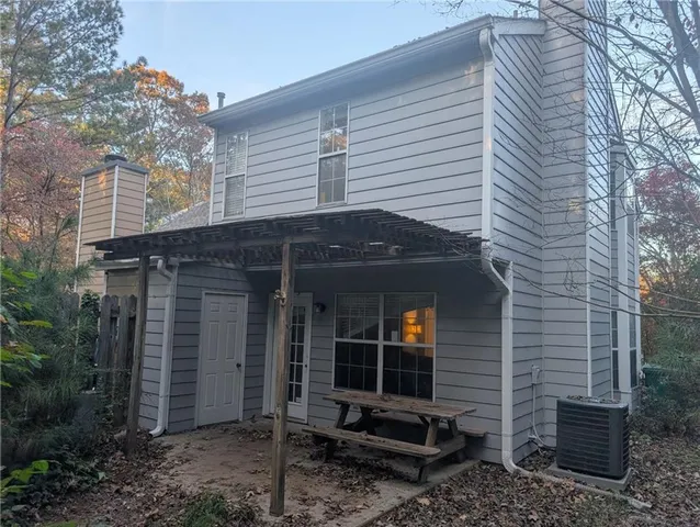 a view of a house that has a small window and potted plants