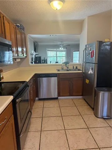 a kitchen with stainless steel appliances granite countertop a sink and cabinets