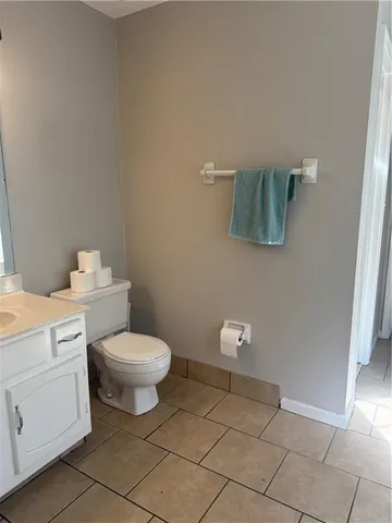 a bathroom with a toilet sink and vanity