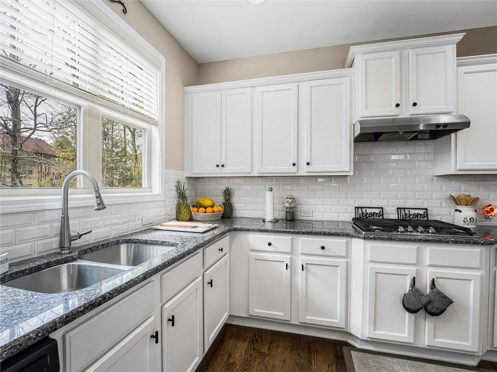 2297 Roberts View Trail Buford, GA 30519 - Photo 19 of 64 a kitchen with white cabinets and a sink