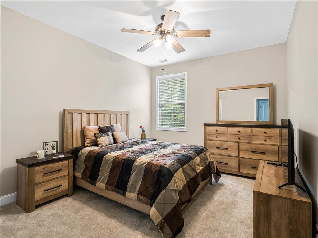 2297 Roberts View Trail Buford, GA 30519 - Photo 24 of 64 a bedroom with a bed and a ceiling fan