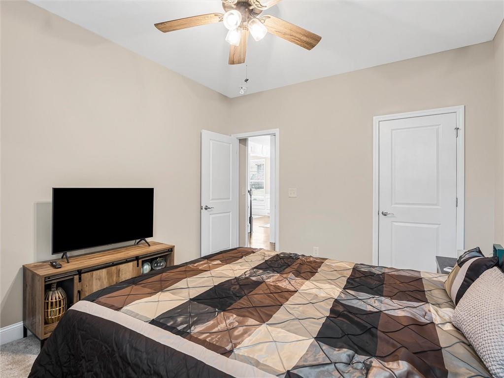 2297 Roberts View Trail Buford, GA 30519 - Photo 25 of 64 a bedroom with bed and flat screen tv