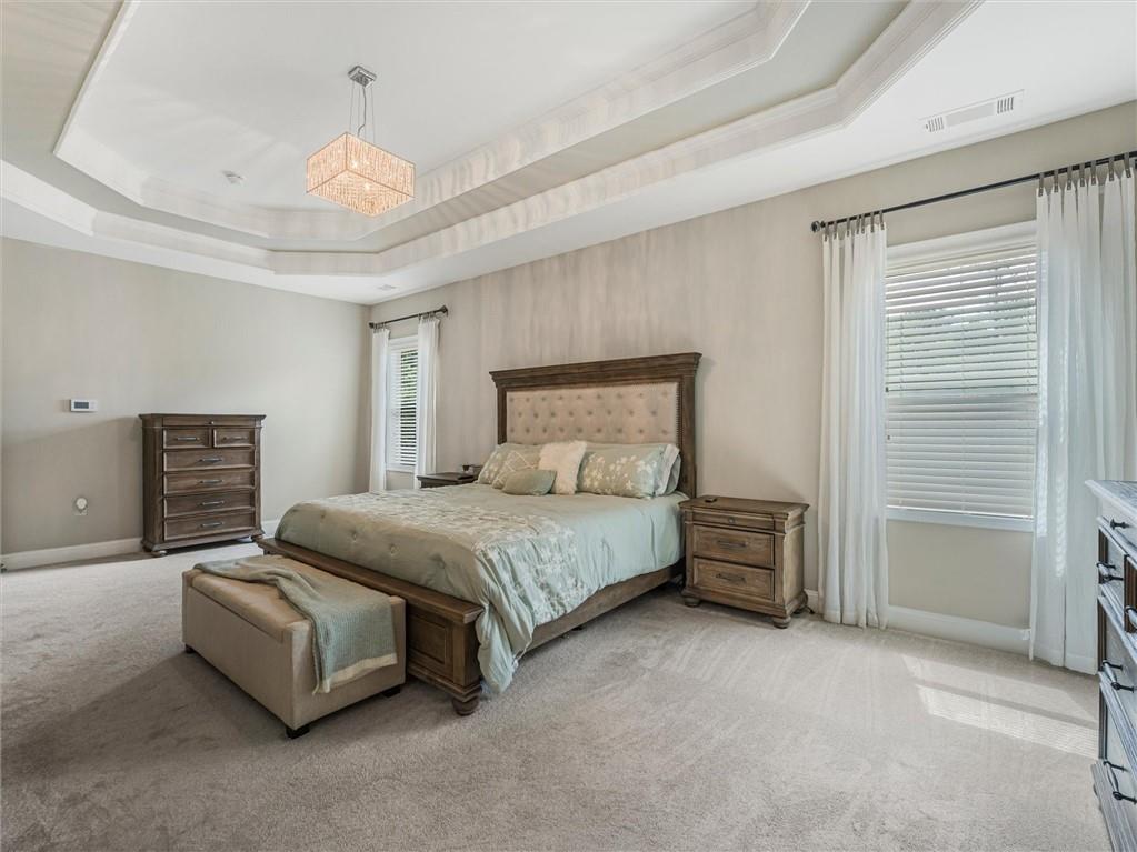 2297 Roberts View Trail Buford, GA 30519 - Photo 33 of 64 a spacious bedroom with a bed and a cabinets