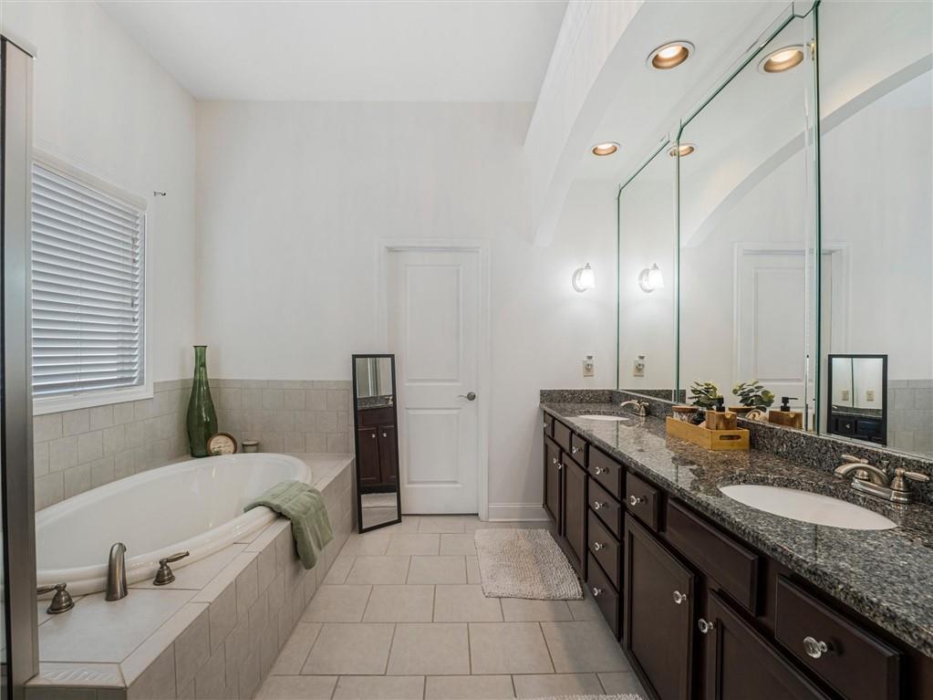 2297 Roberts View Trail Buford, GA 30519 - Photo 34 of 64 a spacious bathroom with a granite countertop sink and a mirror