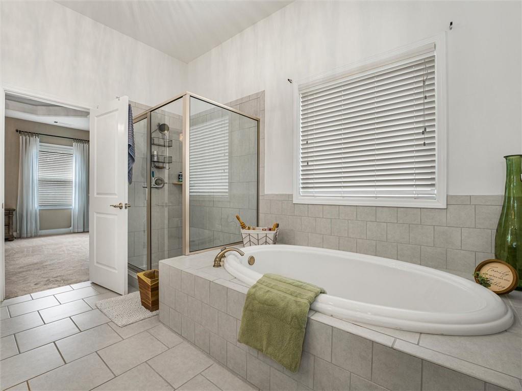 2297 Roberts View Trail Buford, GA 30519 - Photo 36 of 64 a bathroom with a bathtub and a shower
