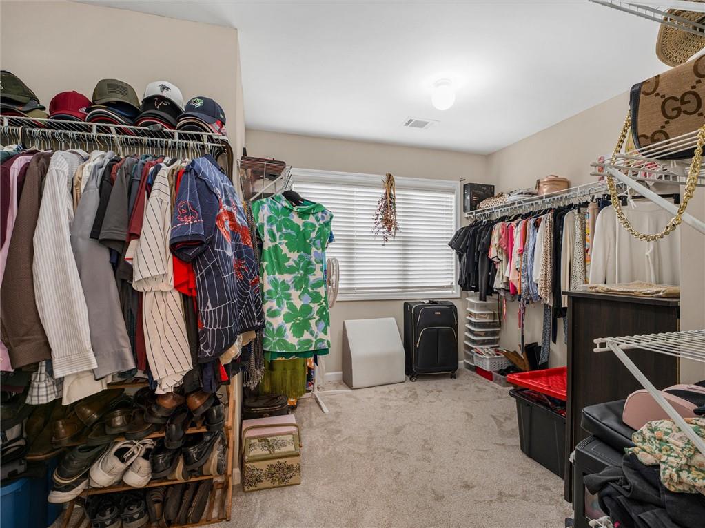 2297 Roberts View Trail Buford, GA 30519 - Photo 37 of 64 a view of walk in closet with clothes and shoes