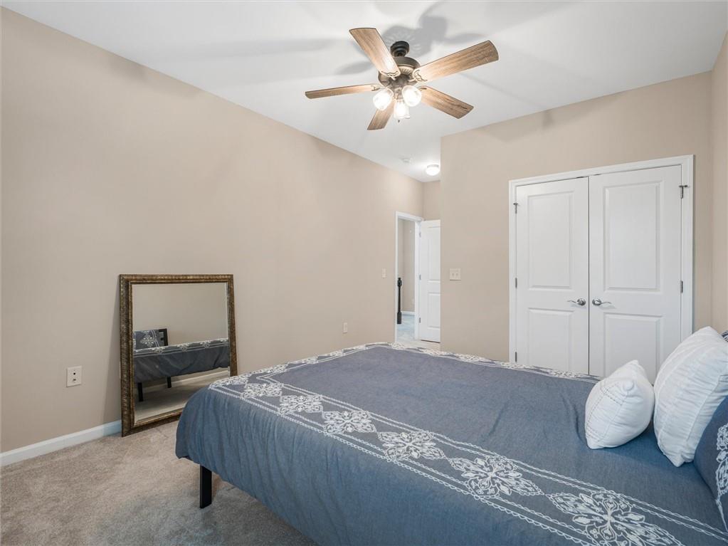 2297 Roberts View Trail Buford, GA 30519 - Photo 42 of 64 a bedroom with a bed and a chandelier