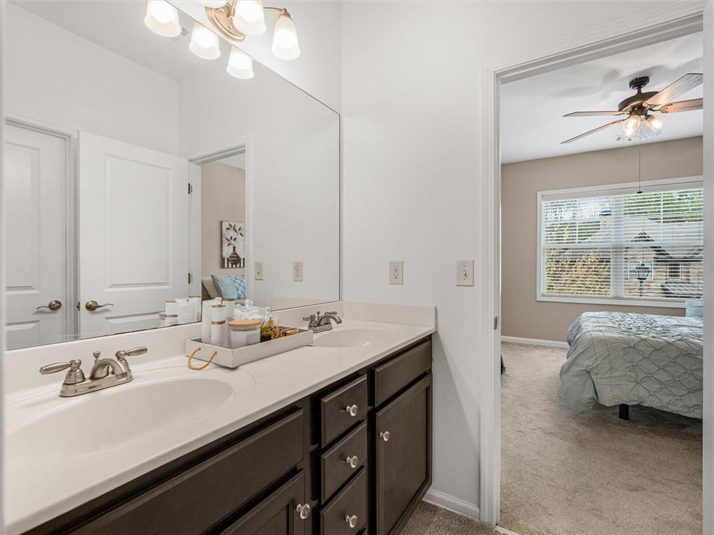 2297 Roberts View Trail Buford, GA 30519 - Photo 43 of 64 a en suite bathroom with double vanity and a mirror