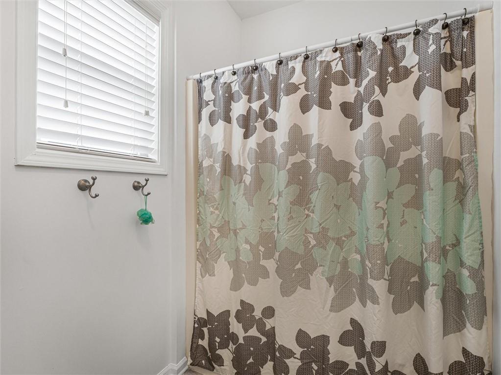 2297 Roberts View Trail Buford, GA 30519 - Photo 44 of 64 a bathroom with a shower curtain