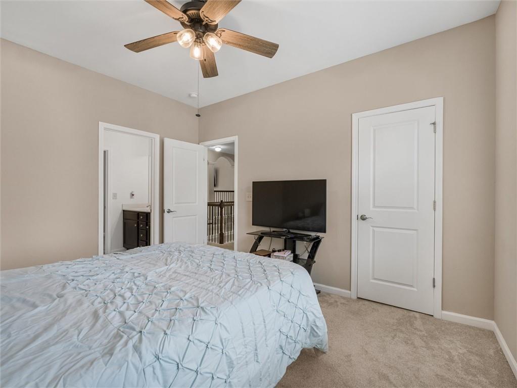 2297 Roberts View Trail Buford, GA 30519 - Photo 46 of 64 a bedroom with a bed and a flat screen tv