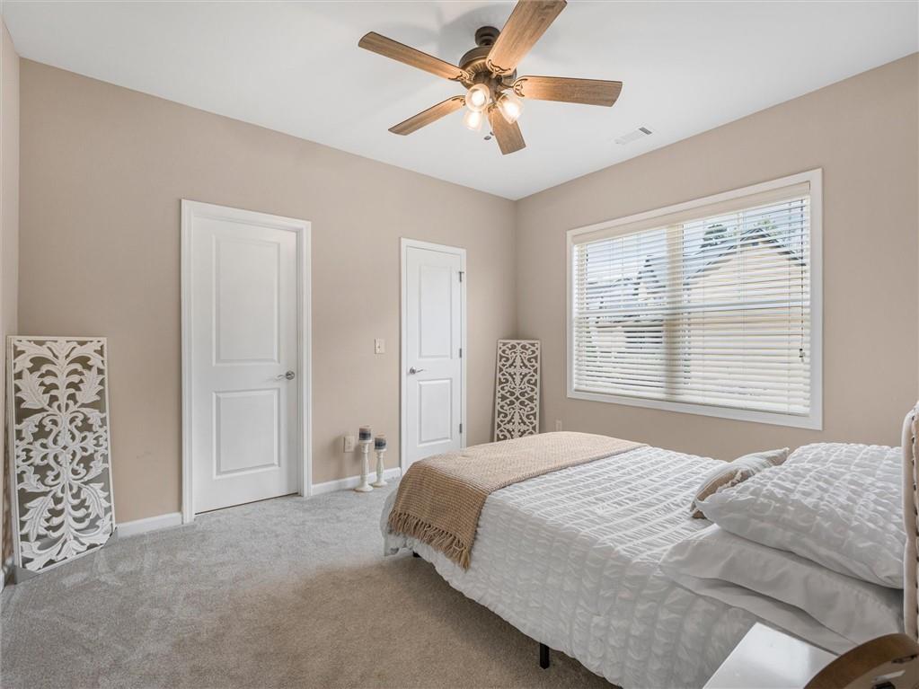 2297 Roberts View Trail Buford, GA 30519 - Photo 47 of 64 a bedroom with a large bed and a window