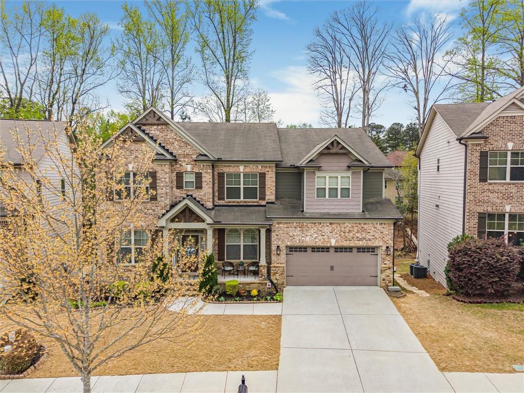 2297 Roberts View Trail Buford, GA 30519 - Photo 57 of 64 a front view of a house with a garden
