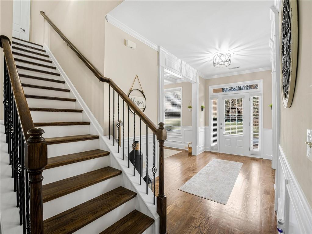 2297 Roberts View Trail Buford, GA 30519 - Photo 8 of 64 a view of a hallway with wooden floor and staircase