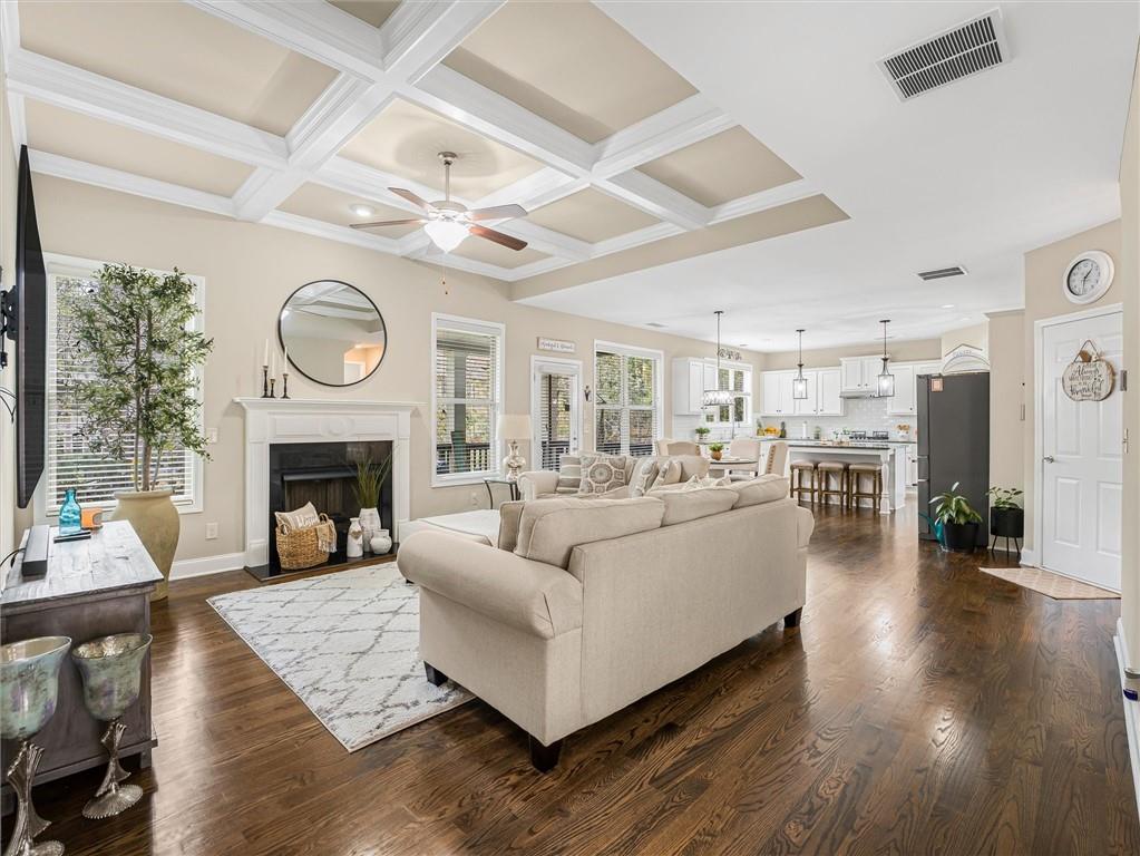 2297 Roberts View Trail Buford, GA 30519 - Photo 9 of 64 a living room with furniture a clock and a fireplace