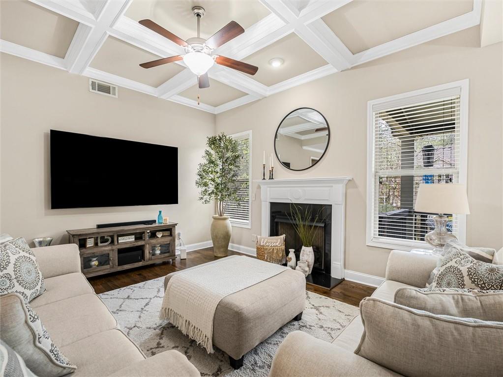 2297 Roberts View Trail Buford, GA 30519 - Photo 10 of 64 a living room with furniture a flat screen tv and a fireplace