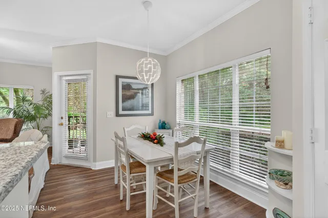 a dining room with furniture and wooden floor