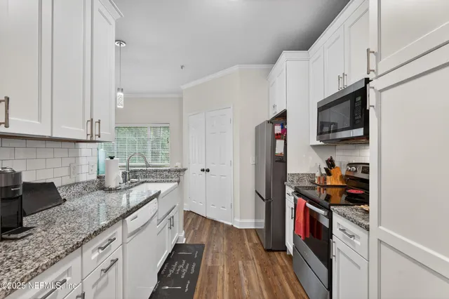 a kitchen with granite countertop lots of counter top space and stainless steel appliances