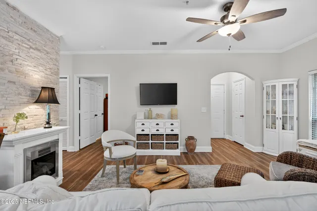 a living room with furniture a fireplace and a flat screen tv