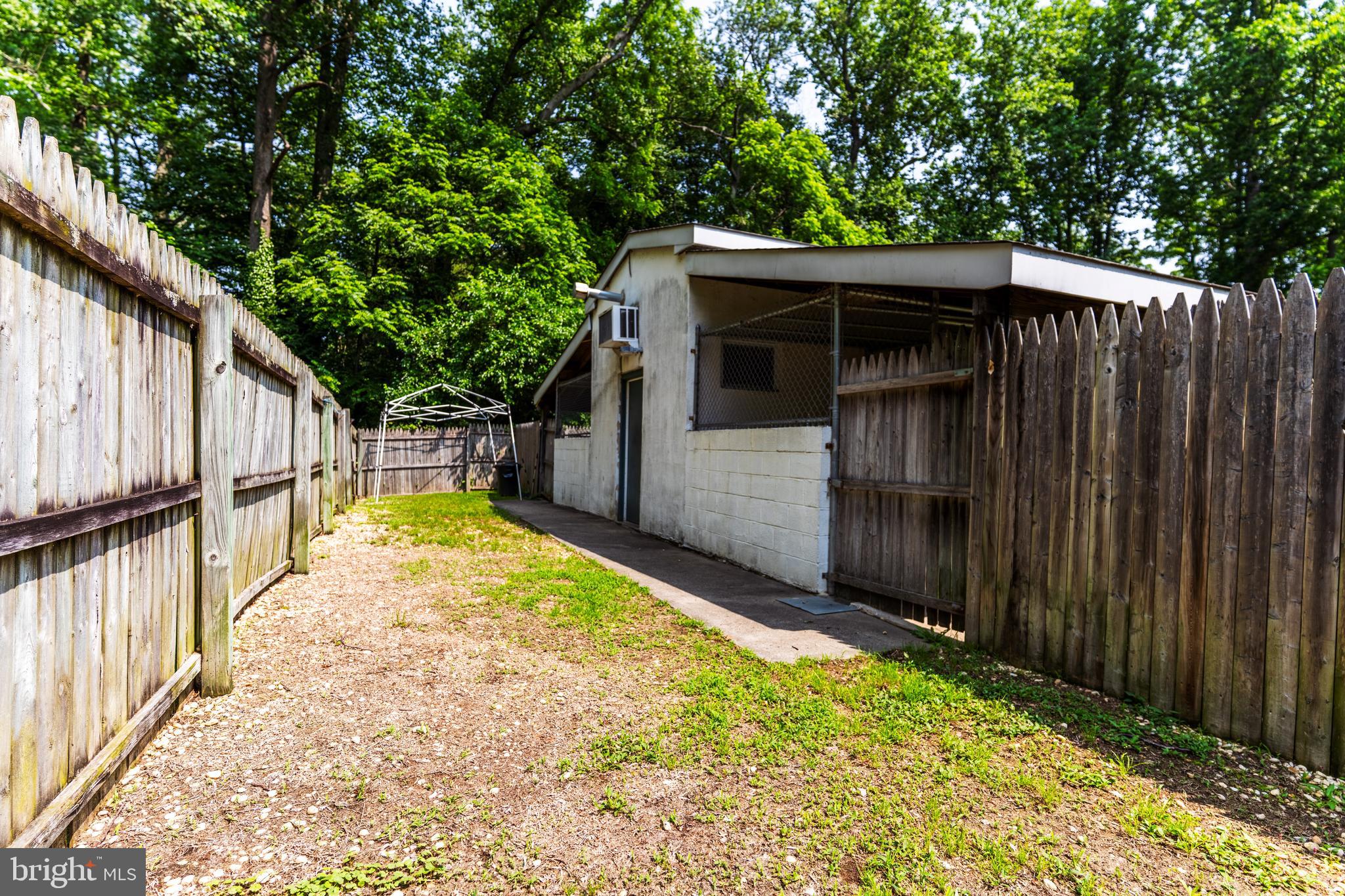 713 Monmouth Road Chesterfield, NJ 08515 - Photo 11 of 25 a view of backyard with small cabin and wooden fencing