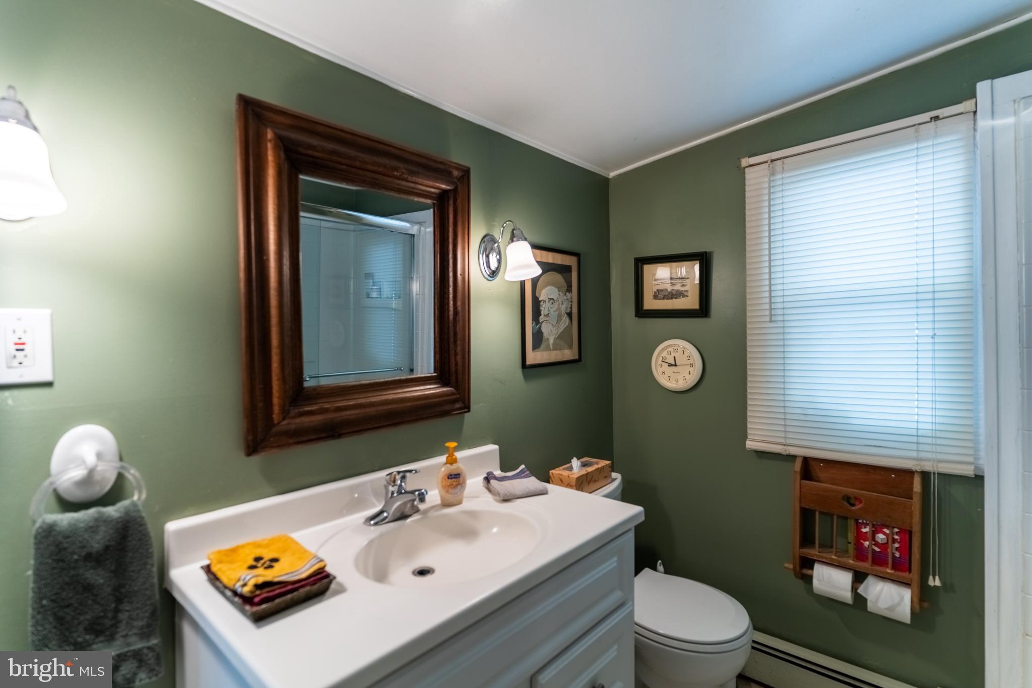 713 Monmouth Road Chesterfield, NJ 08515 - Photo 19 of 25 a bathroom with a toilet a sink and mirror
