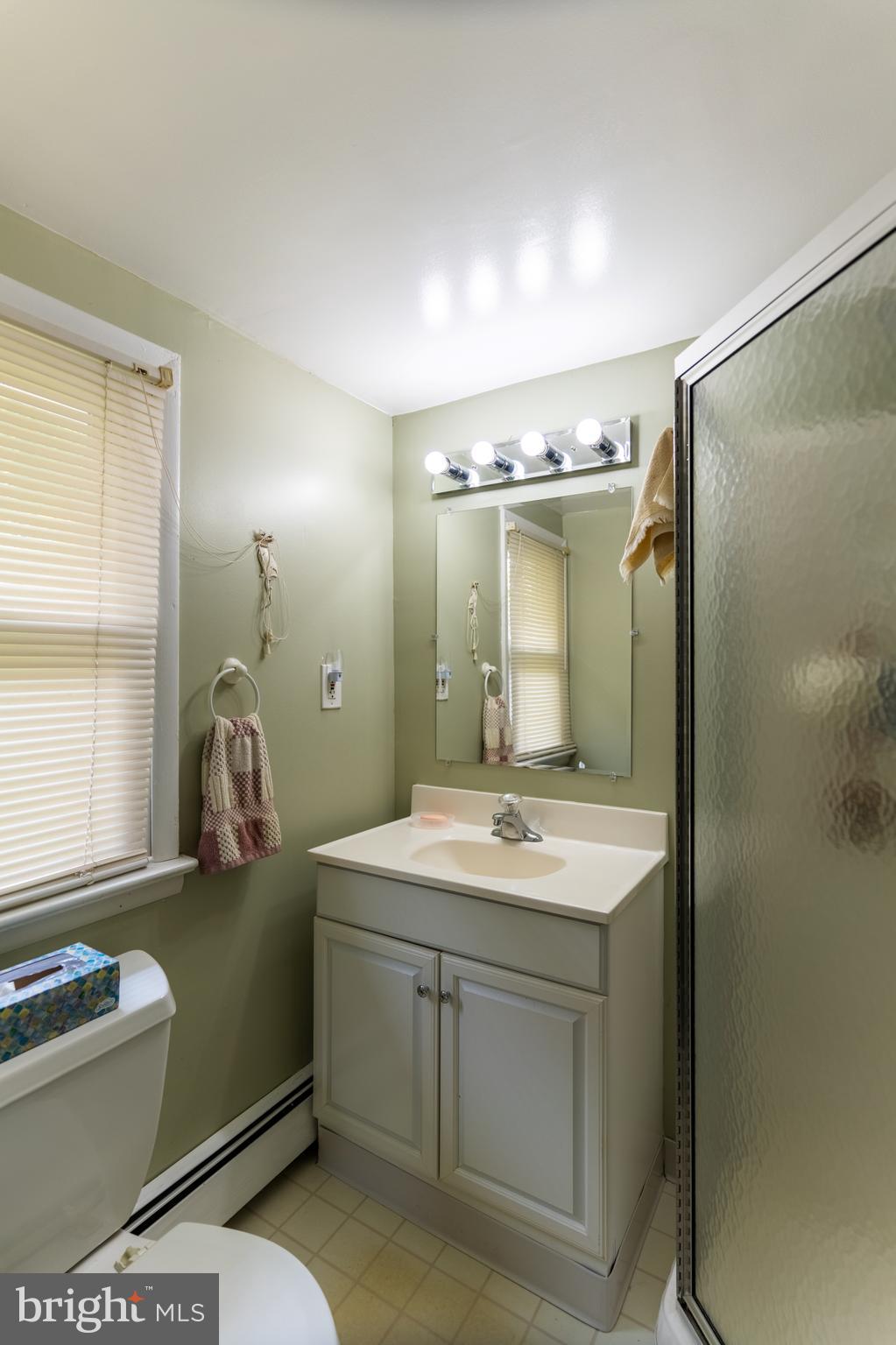 713 Monmouth Road Chesterfield, NJ 08515 - Photo 24 of 25 a bathroom with a sink a toilet and mirror