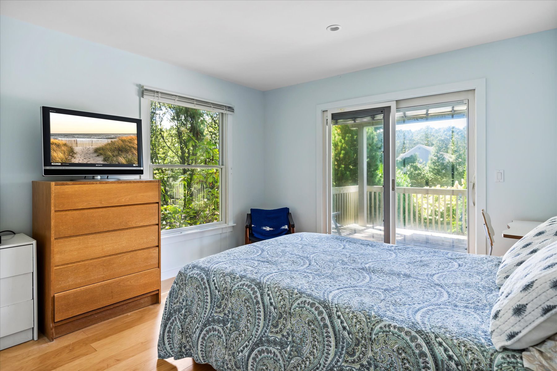 11 Deer Trail Road Southampton, NY 11968 - Photo 13 of 24 a bedroom with a bed television and a window