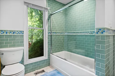 a bathroom with a toilet bathtub and shower