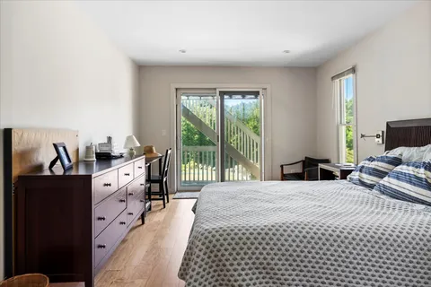 a large bedroom with a bed and a large window