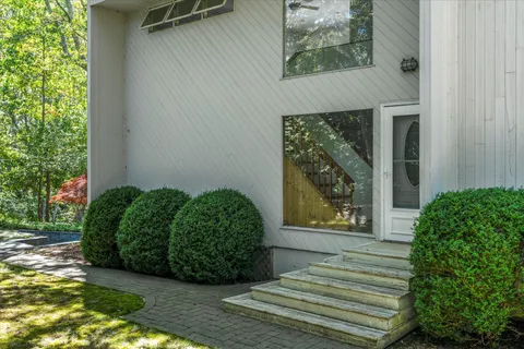a front view of a house with garden
