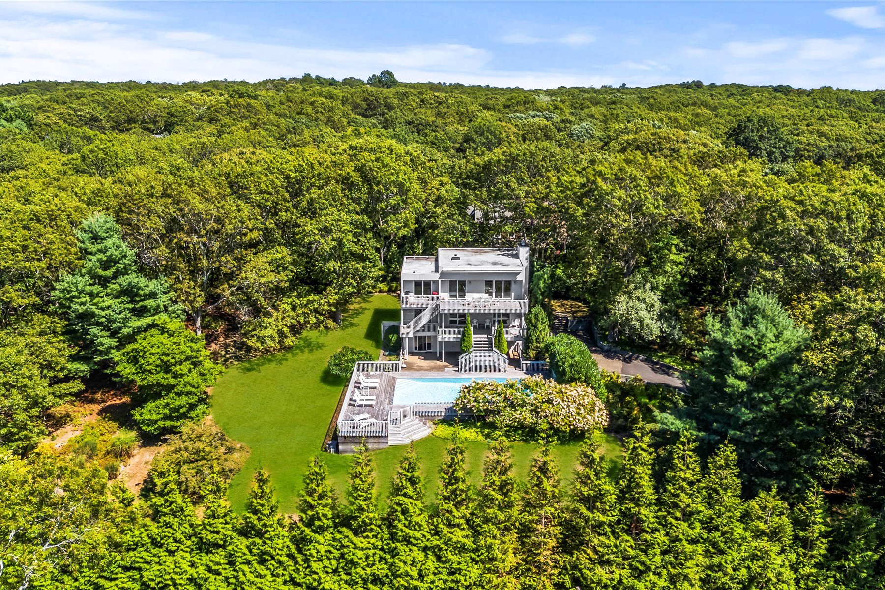 11 Deer Trail Road Southampton, NY 11968 - Photo 3 of 24 front view of a house with a yard