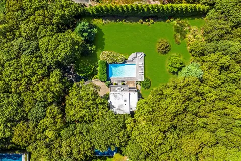 a bird view of a house with a lake view