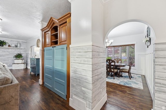 2342 Charros Road Sandy, UT 84092 - Photo 25 of 94 Arched entryway featuring wood-finish flooring and shiplap wall treatment