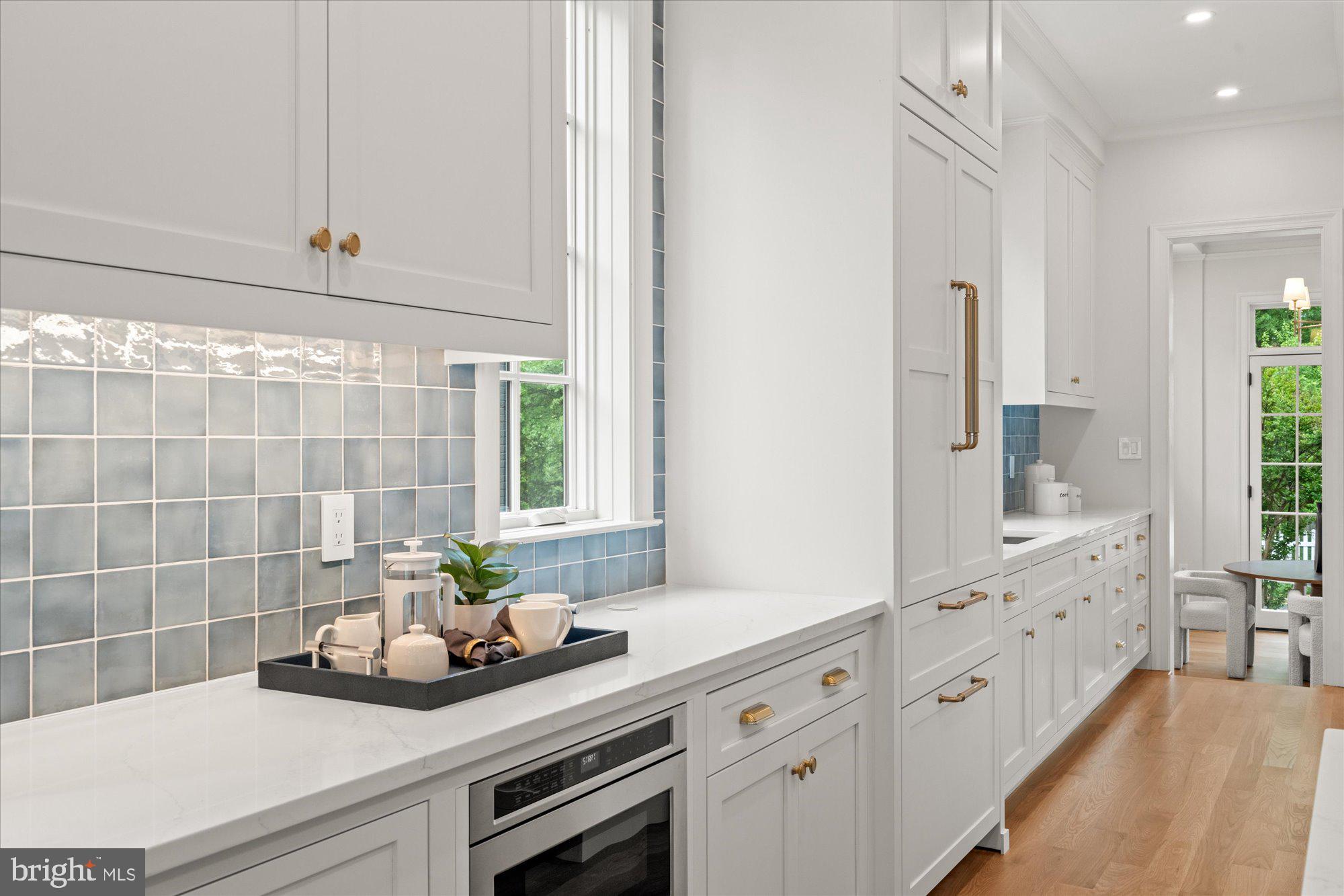 1004 Virginia Avenue Alexandria, VA 22302 - Photo 13 of 63 a bathroom with a double vanity sink a potted plant and a window