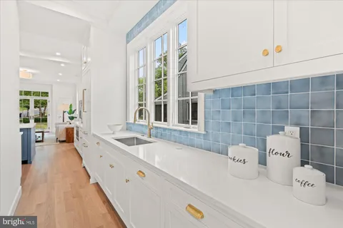 a kitchen that has a sink and a stove