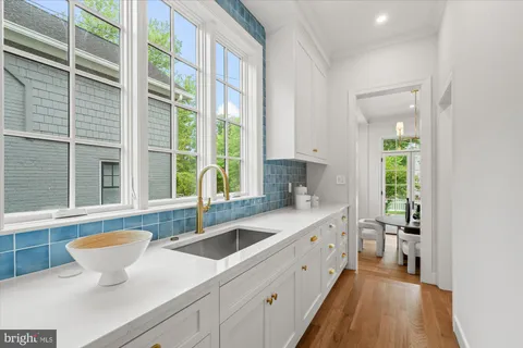 a bathroom with a sink a toilet and a refrigerator