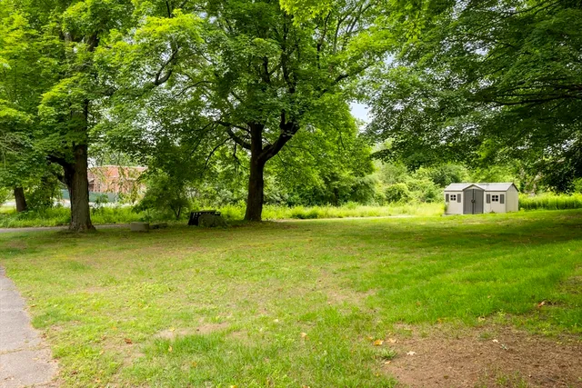 a front view of a house with a big yard
