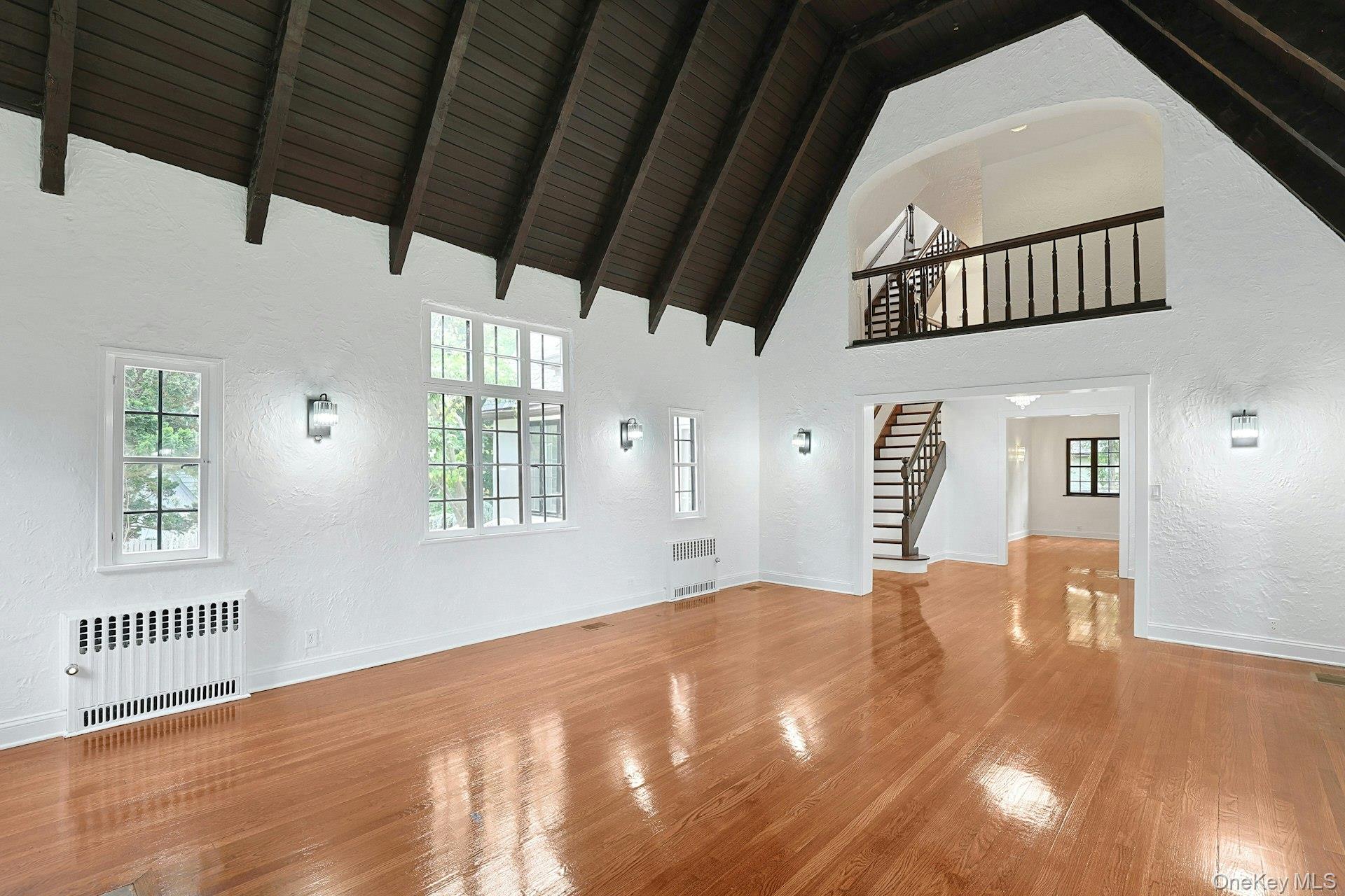 14 Withington Road Scarsdale, NY 10583 - Photo 10 of 41 a view of a big room with wooden floor and windows