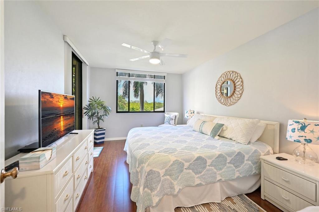 17 Bluebill Avenue, Unit 101 Naples, FL 34108 - Photo 15 of 23 a bedroom with a bed and a flat screen tv