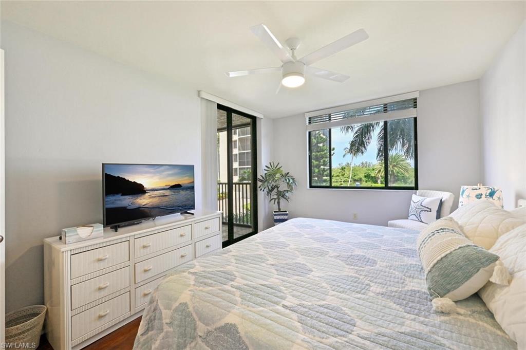 17 Bluebill Avenue, Unit 101 Naples, FL 34108 - Photo 16 of 23 a bedroom with a bed and a flat screen tv