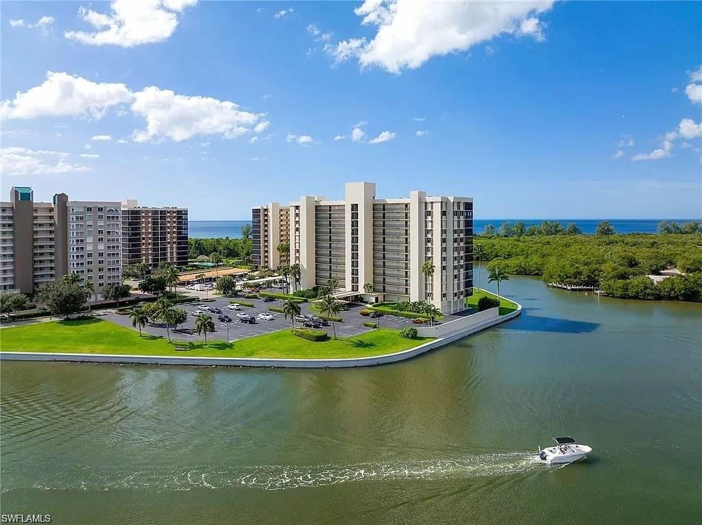 17 Bluebill Avenue, Unit 101 Naples, FL 34108 - Photo 21 of 23 a view of a lake with a city