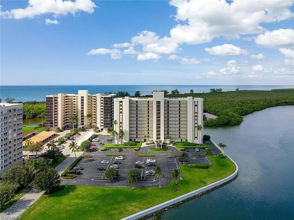 17 Bluebill Avenue, Unit 101 Naples, FL 34108 - Photo 23 of 23 a view of a house with backyard outdoor seating and lake