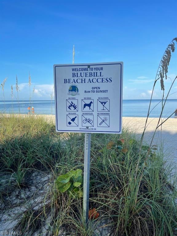 17 Bluebill Avenue, Unit 101 Naples, FL 34108 - Photo 4 of 23 a sign that is sitting on a wooden fence