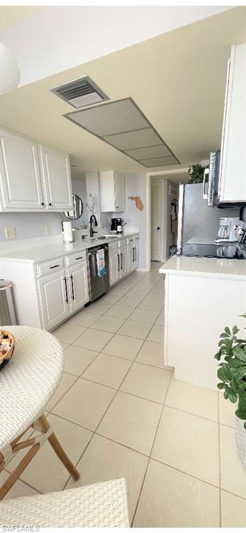 17 Bluebill Avenue, Unit 101 Naples, FL 34108 - Photo 7 of 23 a kitchen with stainless steel appliances kitchen island granite countertop a sink and white cabinets