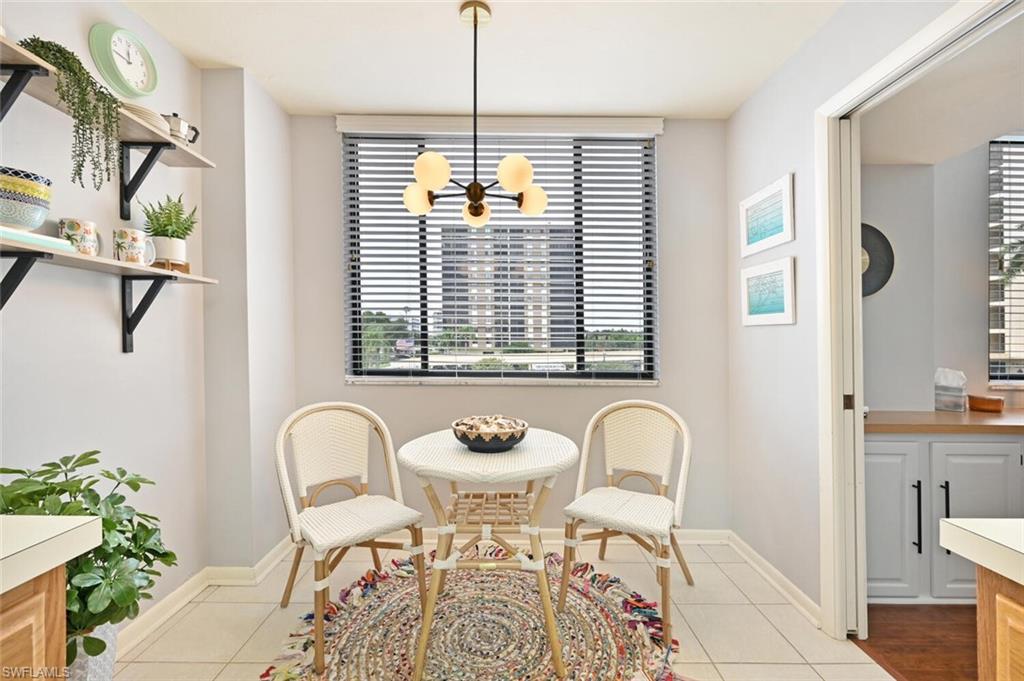 17 Bluebill Avenue, Unit 101 Naples, FL 34108 - Photo 10 of 23 a bathroom with a granite countertop sink and a mirror
