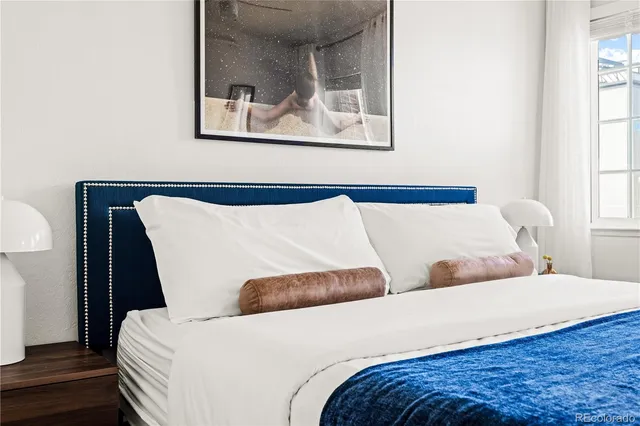 a bedroom with bed and cupboard