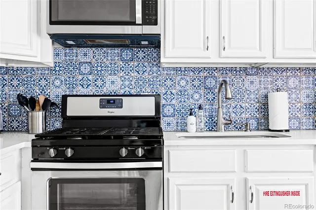 a stove top oven sitting inside of a kitchen
