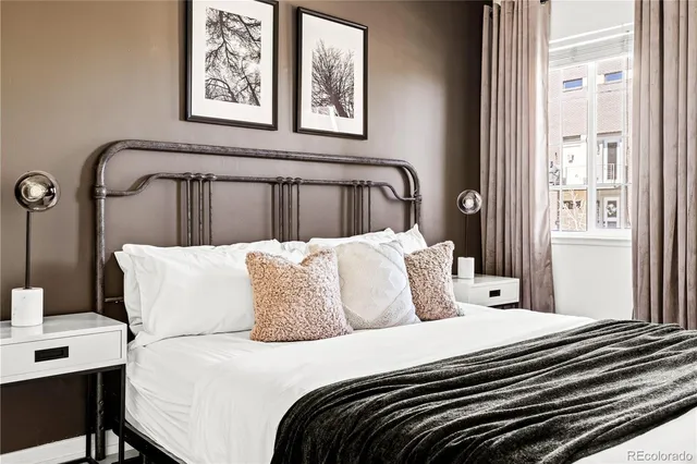 a bedroom with a large bed and a window