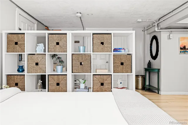 a very nice looking bedroom with a large bed and wooden floor