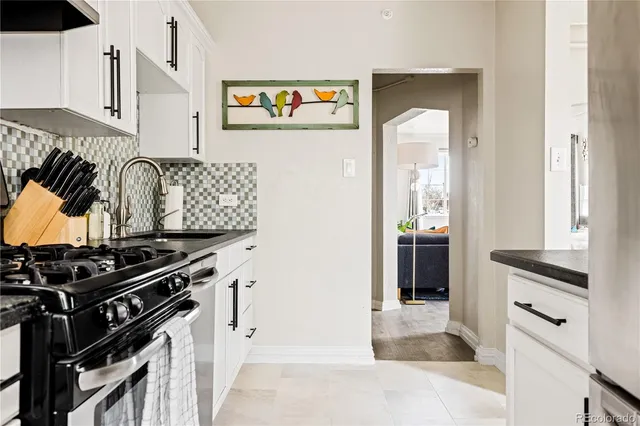 a kitchen with stainless steel appliances granite countertop a stove and a refrigerator